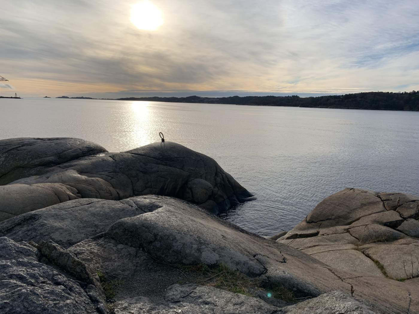 Beautiful sunrise over the ocean with large boulders in the foreground.